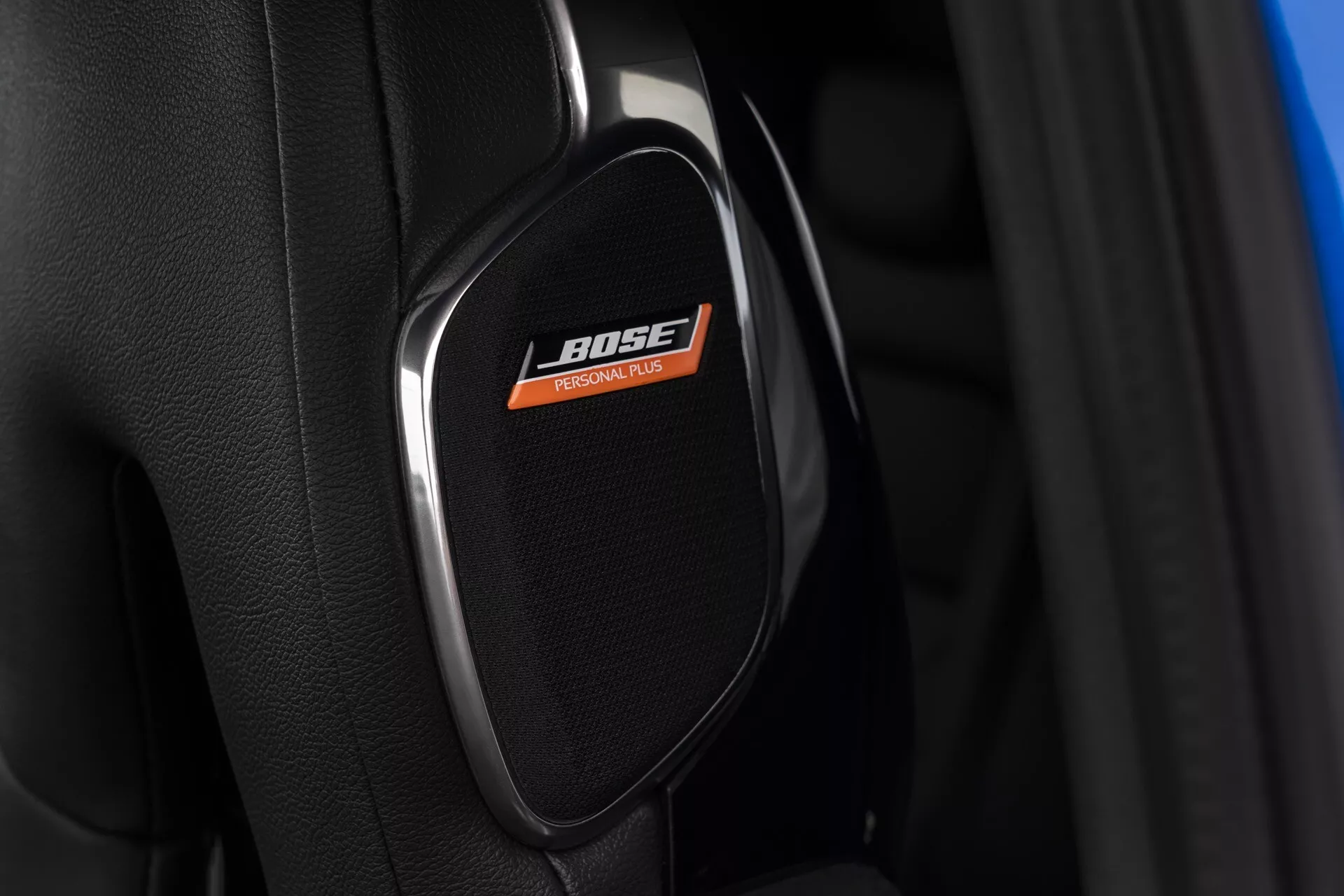 Posnetek iz bližine premium pokrova zvočnika znamke BOSE v Nissan Juke 2019 (F16), ki poudarja tehnologijo visokokakovostnega avdio sistema znotraj luksuzne notranjosti avtomobila.