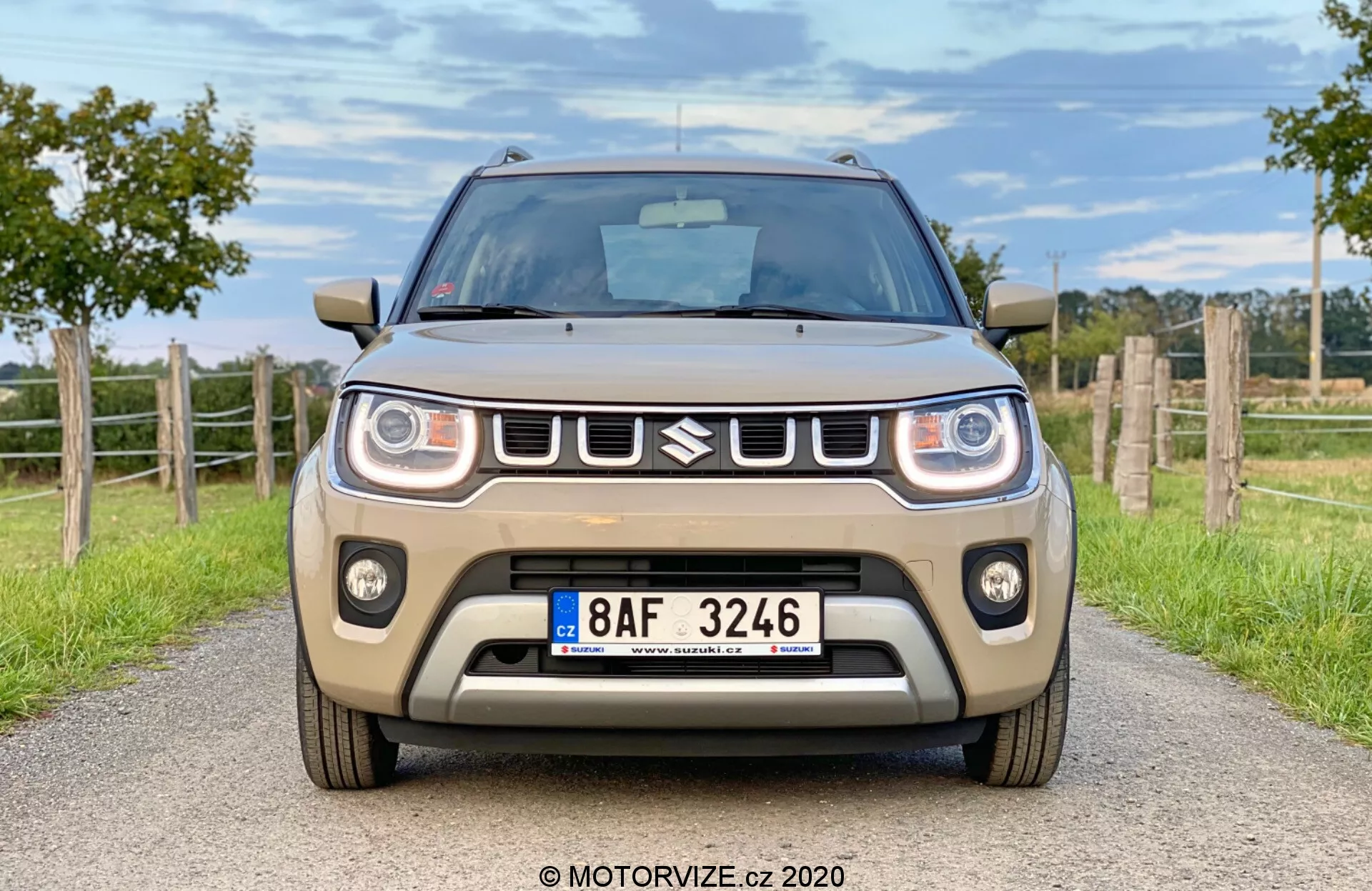 Stranski pogled spredaj na Suzuki Ignis 2020 1.2 Dualjet Hybrid Club v urbanem okolju, ki poudarja kompaktno zasnovo, sodobne žaromete in drzno rešetko.